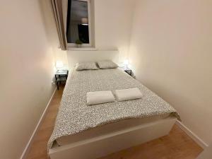 a bedroom with a bed with two pillows on it at Apartament w centrum Konina in Konin