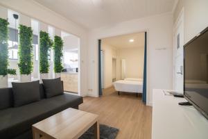 a living room with a couch and a tv at Livramento Residence in Livramento