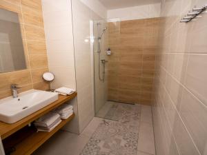 a bathroom with a sink and a shower at Residence Sarka in Prague +68 photos