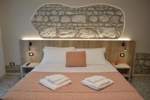 a bedroom with a bed with two towels on it at B&B Casa Anì in Pordenone
