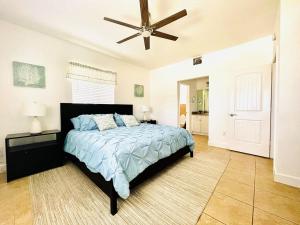 a bedroom with a bed and a ceiling fan at Sunset Bliss in Abbeyville