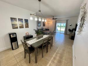 a dining table and chairs in a living room at Sunset Bliss in Abbeyville