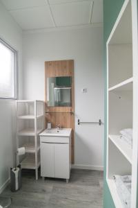 a white bathroom with a sink and a mirror at Livramento Residence in Livramento +39 photos