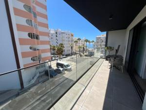 an apartment balcony with a view of a city at NEW Apartment, Sea Front & Shared Pool in Quarteira
