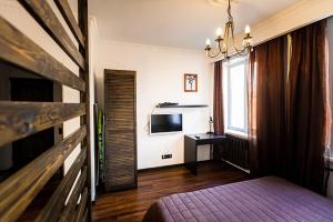 a bedroom with a bed and a television in it at Apartment on Sibirskaya st. 33 in Novosibirsk