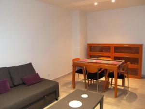 a living room with a couch and a table at Apartment in Estartit with garden in L'Estartit +29 photos