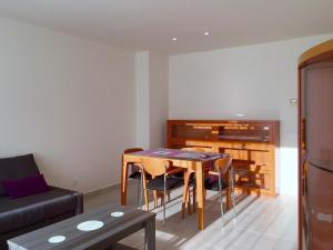 a living room with a table and a piano at Apartment in Estartit with garden in L'Estartit