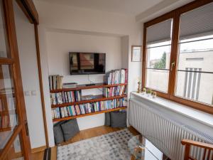 a living room with bookshelves and a window at Residence Sarka in Prague