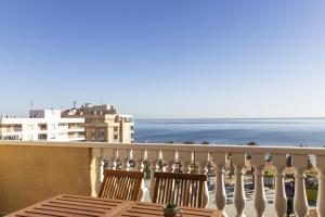 a balcony with two chairs and a view of the ocean at Penthouse Pink seafront in La Mata