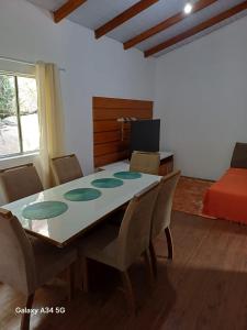 a room with a table and chairs and a bed at Mar e descanso in São Sebastião +6 photos