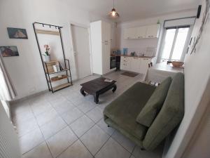 a living room with a couch and a table at Centre ville Douarnenez in Douarnenez