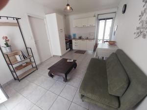 a living room with a couch and a table at Centre ville Douarnenez in Douarnenez