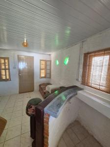 a room with a fireplace in the middle of a room at Casa Hermena in Santa Vitória do Palmar