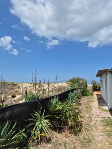 a wall with plants next to a building at Casa Hermena in Santa Vitória do Palmar