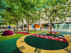 a playground in a city with trees and a building at Apartmani Mursa-blizina KBC Osijek in Osijek