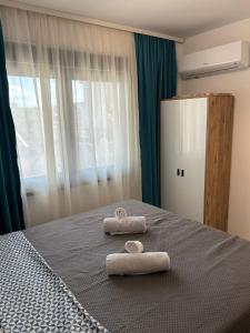 a bedroom with two towels on a bed at Nik 2 in Kruševac +1 photo