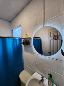 a bathroom with a mirror and a sink and a toilet at Las Palmeritas in Ahuachapán +17 photos