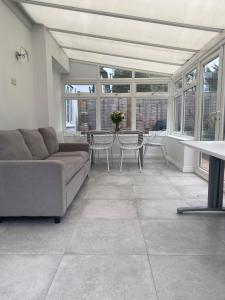 a living room with a couch and a table at Luxury 2-Bed Apartment with Parking & Garden in Borehamwood