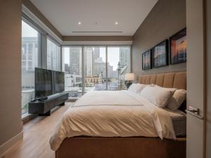 a bedroom with a large bed and a large window at Stay One Chicago in Chicago +31 photos