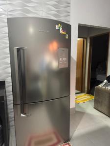 a stainless steel refrigerator sitting in a kitchen at Casa de temporada in Trindade