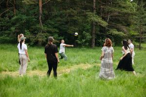 a group of people playing frisbee in a field at Maglian Forest Retreat in Divčibare +120 photos