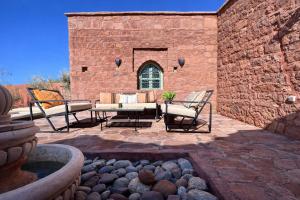 a patio with a table and chairs and a fountain at Villa Al Firdaous in Tiznit
