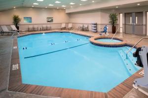 a large swimming pool with a person walking by it at Delta Hotels by Marriott Seattle Everett in Everett