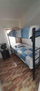 two bunk beds in a room with a wooden floor at Hostal Pura Vida in Santiago
