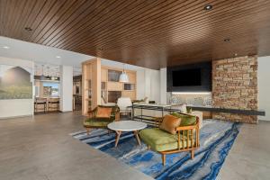 a living room with a couch and chairs and a table at Fairfield Inn & Suites Dixon in Dixon