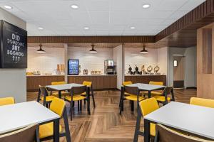 a dining room with tables and yellow chairs at Fairfield Inn & Suites Dixon in Dixon