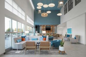 a lobby with a couch and chairs and a table at Element by Marriott Opelika Auburn in Opelika