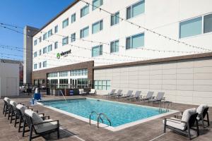 a swimming pool in front of a building at Element by Marriott Opelika Auburn in Opelika