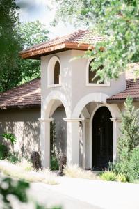 a small house with an arched entry way at Messina Inn in Wimberley