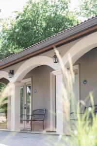 a porch with a chair on a house at Messina Inn in Wimberley +39 photos