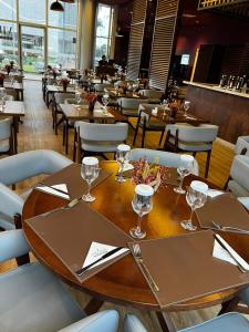 a restaurant with tables and chairs with wine glasses on them at Ap Tryp by Wyndham Nações in Brasília