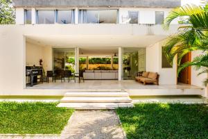 an open living room and patio of a house at 11BR I Hacienda Zalama in Tulum