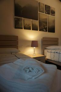 a bedroom with two beds and a table with a lamp at Villa Castaldi Firenze vicina al centro in Florence
