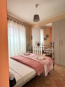 a bedroom with a large bed and a mirror at Casa Amelia - Charme in Taormina in Taormina