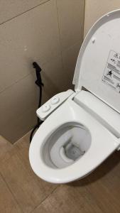 a white toilet with the seat up in a bathroom at Bangkok villa with 3 bedrooms in Ban Zong Katiam