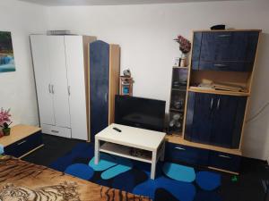 a bedroom with a bed and a tv and a table at CasaLoco in Mediaş