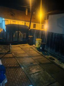 a street at night with three trash cans and a fence at CasaLoco in Mediaş