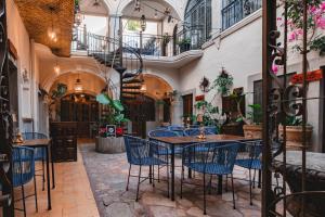 a restaurant with blue chairs and a table in a building at Te Amo Hotel Boutique in San Miguel de Allende