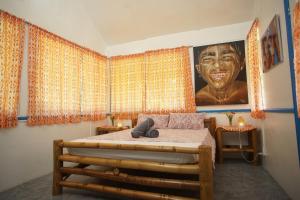a bedroom with a large portrait of a man at Sun House Rental in Mambajao +201 photos