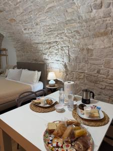 a table with a plate of food on top of it at Casa La Grotta in Bitonto