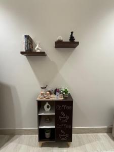 a small table with shelves on a wall at شقة فاخرة in Al Kharj +1 photo