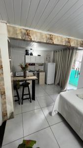 a room with a kitchen and a table in a room at Kit net morro de são Paulo in Cairu +4 photos