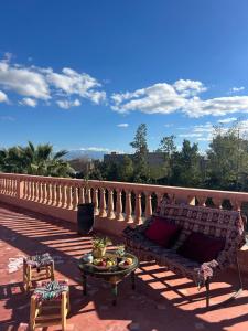 a couch and a table on a balcony at Villa Essalah & Spa Marrakech in Marrakesh