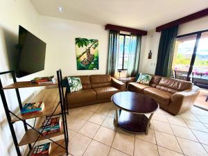 a living room with a couch and a table at Breezy Paradise 2 bed2bath with mountain view in Coco