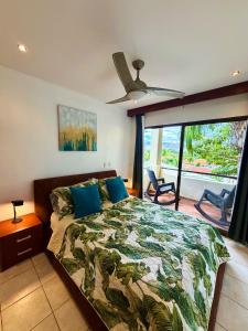 a bedroom with a bed and a ceiling fan at Breezy Paradise 2 bed2bath with mountain view in Coco +59 photos