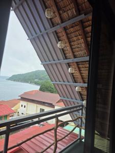 a view of the water from the balcony of a house at Romantic Ocean View A-Frame with Shore Diving Access - Aloha Aina Dive Resort in Mabini +2 photos